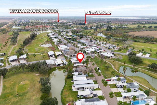 aerial view with golf course view, a water view, and a residential view