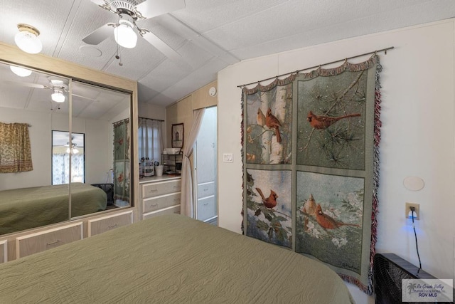 unfurnished bedroom with lofted ceiling, a ceiling fan, and a closet