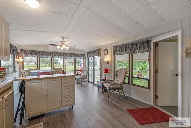 kitchen featuring lofted ceiling, dark wood-style flooring, light countertops, and ceiling fan