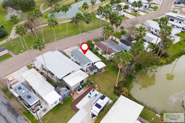 birds eye view of property with a water view and a residential view