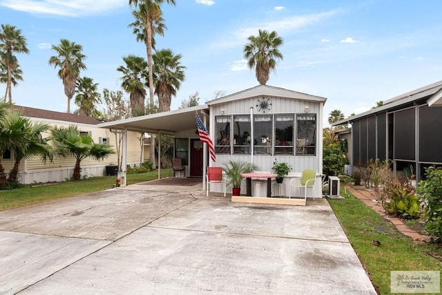 view of front of house featuring a carport and driveway