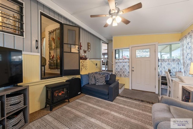 living area with ceiling fan and carpet flooring