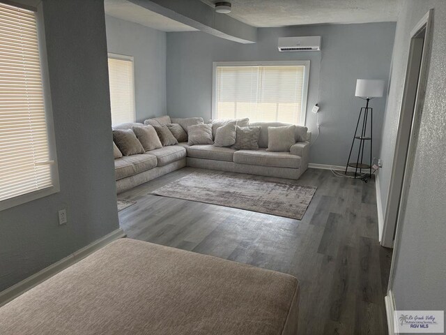 spare room featuring beamed ceiling, a textured ceiling, and dark hardwood / wood-style flooring