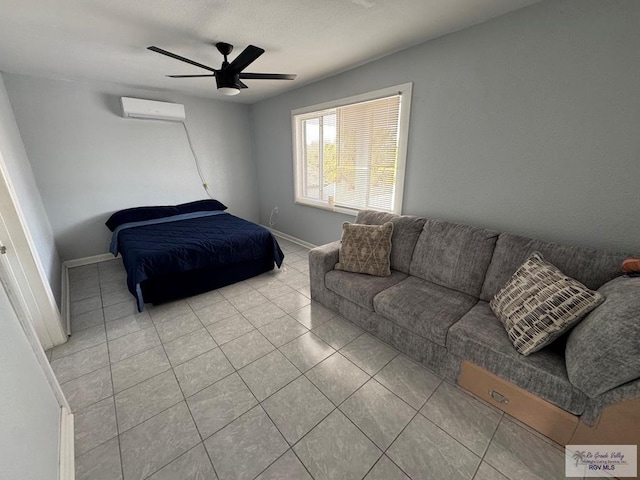 bedroom featuring a ceiling fan, an AC wall unit, baseboards, and light tile patterned floors