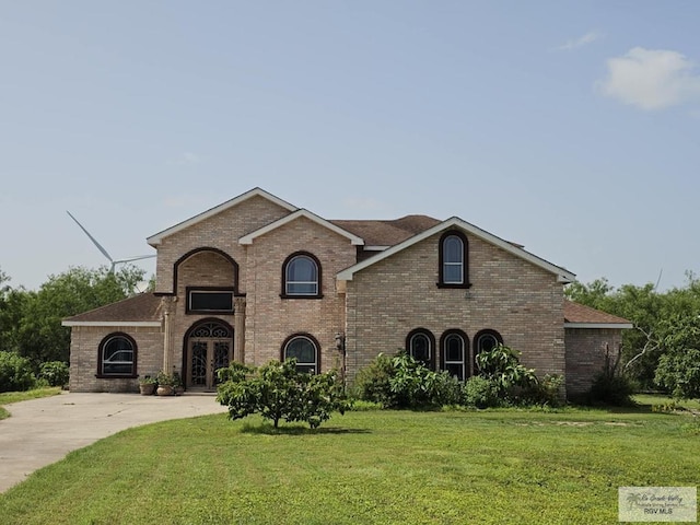 french country style house with french doors and a front yard