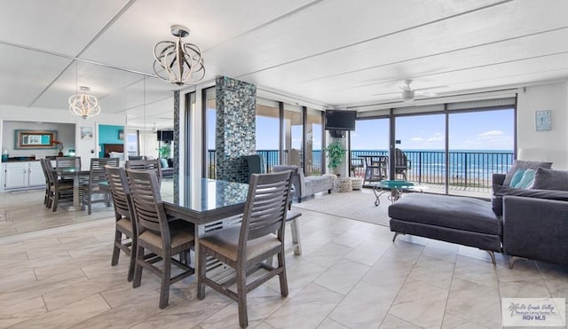 3000 Gulf Blvd, South Padre Island, TX 78597 - dining area with a chandelier, floor to ceiling windows, and ceiling fan