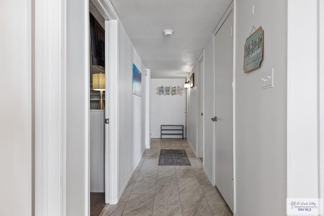 3000 Gulf Blvd, South Padre Island, TX 78597 - hallway featuring light marble finish floors and baseboards