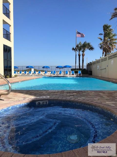3000 Gulf Blvd, South Padre Island, TX 78597 - community pool with a hot tub and a patio area