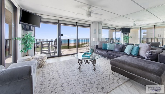 3000 Gulf Blvd, South Padre Island, TX 78597 - living area featuring expansive windows and a ceiling fan