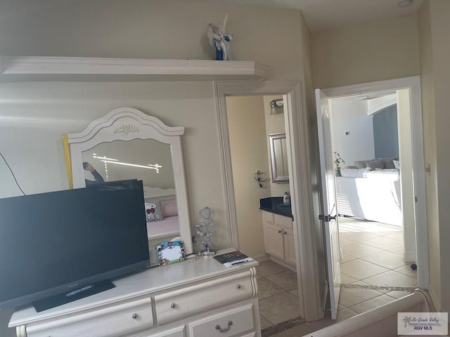 bedroom featuring light tile patterned floors