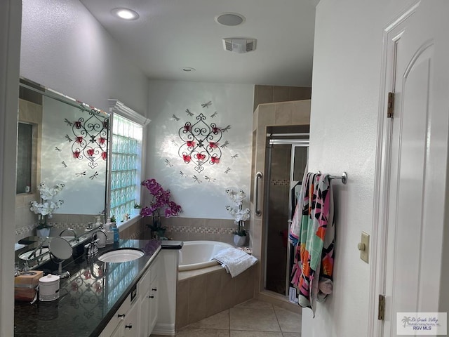 bathroom featuring tile patterned flooring, vanity, and plus walk in shower