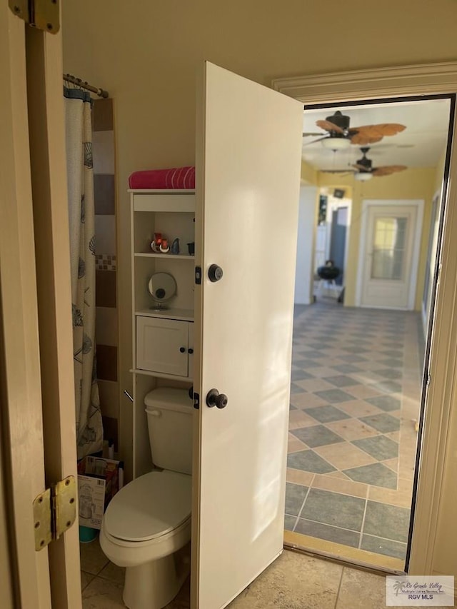 bathroom featuring toilet and ceiling fan