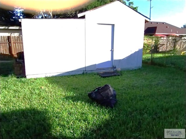 view of outdoor structure with a lawn