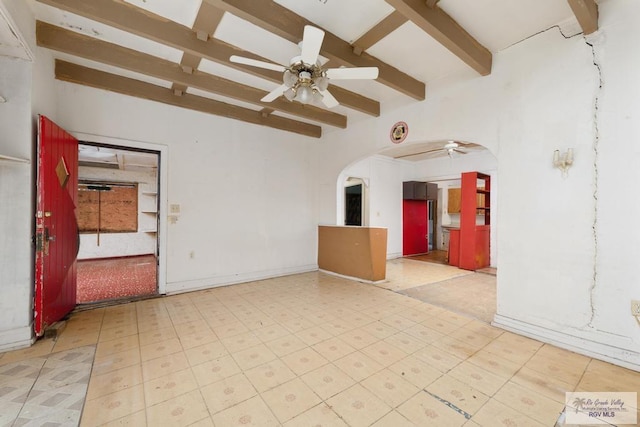 spare room featuring beamed ceiling and ceiling fan