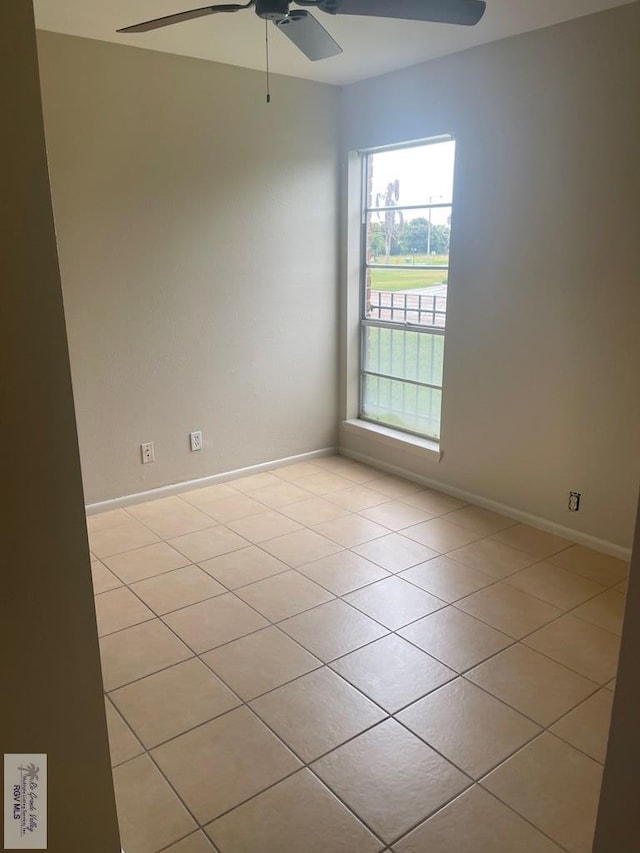 tiled empty room with ceiling fan