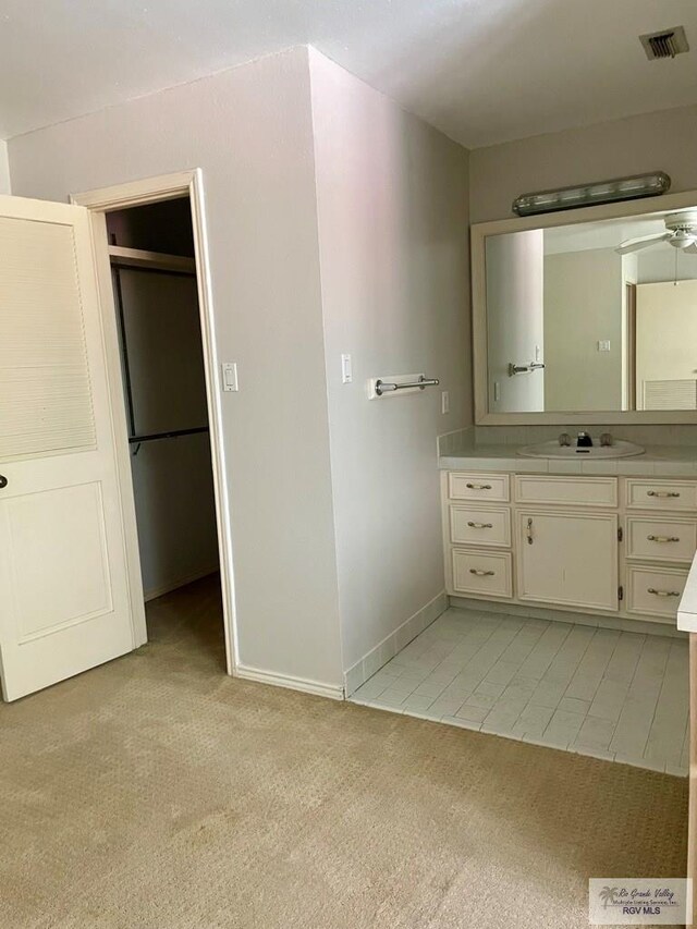 bathroom featuring tile patterned floors, vanity, and ceiling fan