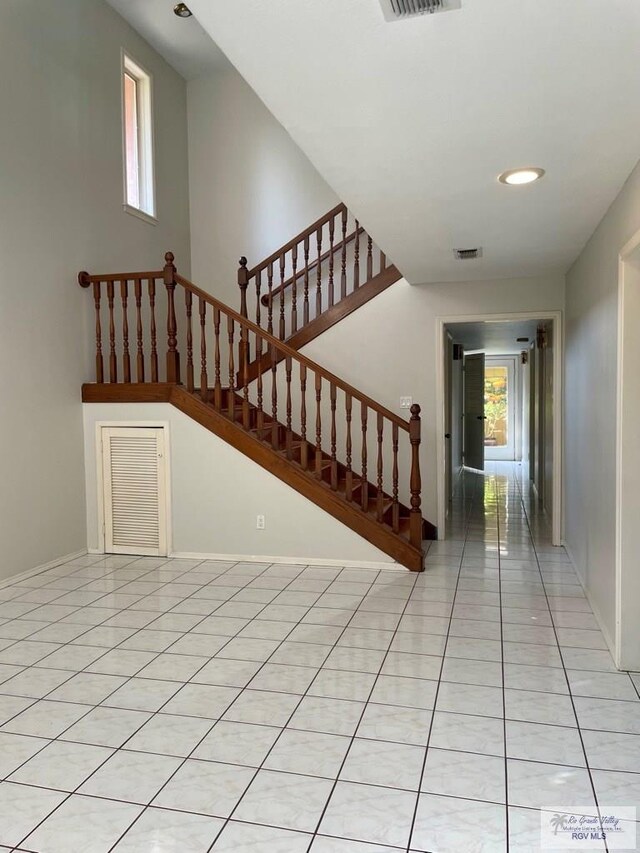 stairs featuring tile patterned flooring