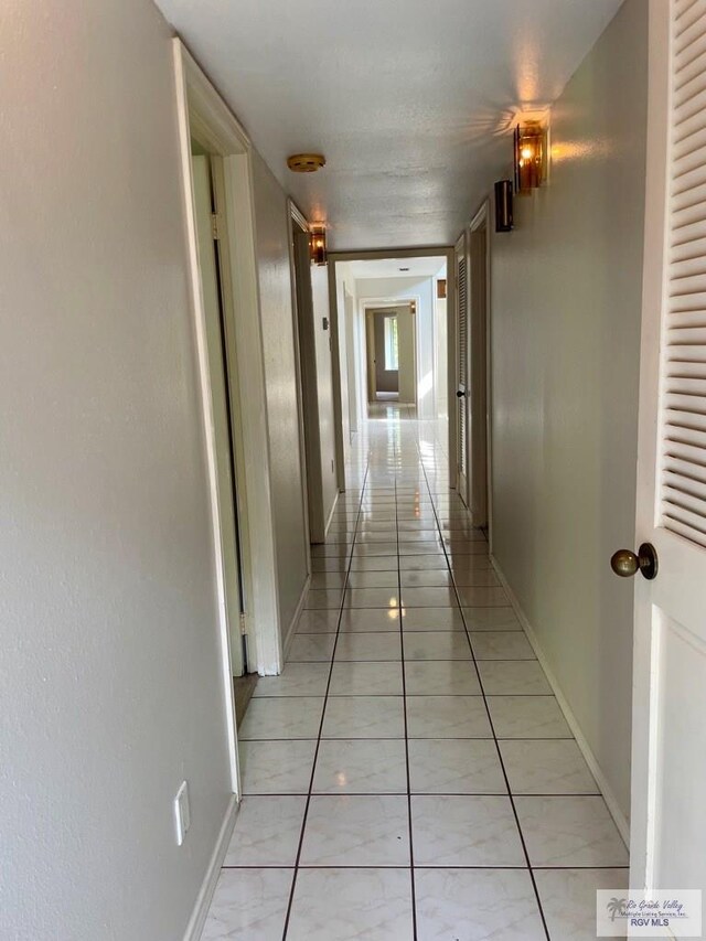 hall featuring light tile patterned flooring