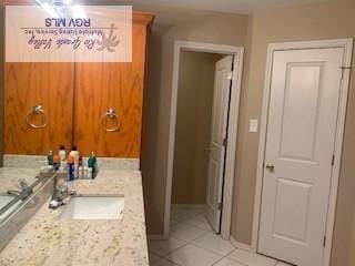 bathroom featuring tile patterned flooring and vanity