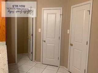 hallway with light tile patterned flooring