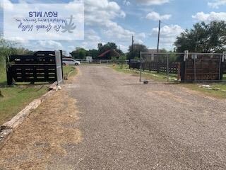 view of road featuring driveway and a gated entry