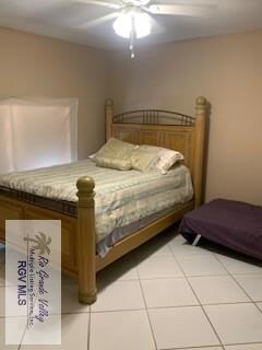 bedroom featuring light tile patterned floors and a ceiling fan