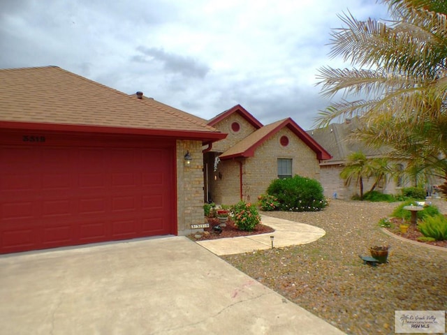 3319 Country Club Dr, Edinburg, TX 78542 - view of front of property featuring an attached garage, driveway, stone siding, and a shingled roof