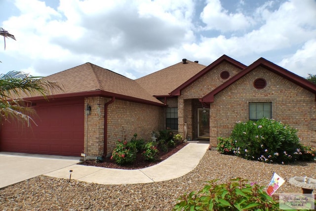 3319 Country Club Dr, Edinburg, TX 78542 - view of front of house featuring a shingled roof, an attached garage, brick siding, and concrete driveway