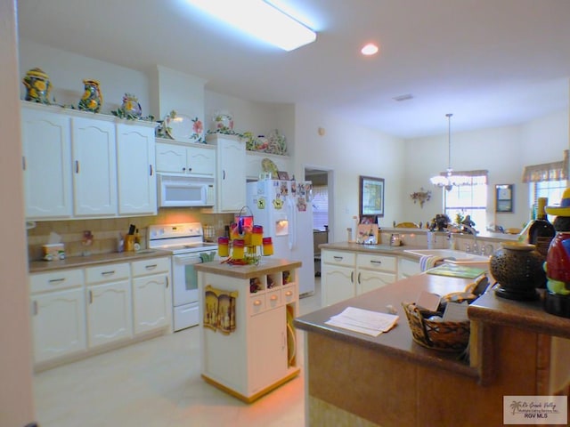 3319 Country Club Dr, Edinburg, TX 78542 - kitchen featuring white appliances, white cabinetry, a chandelier, a center island, and recessed lighting