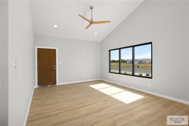 spare room featuring ceiling fan, light hardwood / wood-style flooring, and high vaulted ceiling