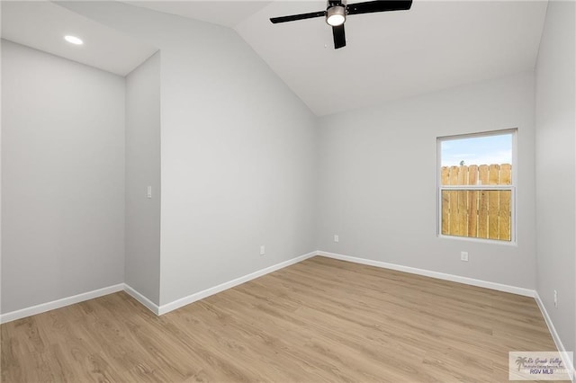 empty room featuring ceiling fan, vaulted ceiling, and light hardwood / wood-style flooring