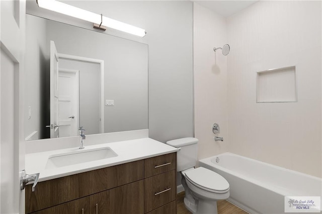 full bathroom featuring vanity, wood-type flooring, bathtub / shower combination, and toilet