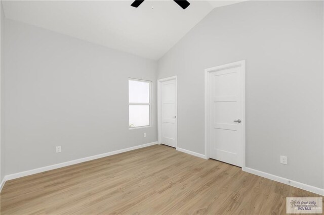 unfurnished bedroom with ceiling fan, light hardwood / wood-style floors, and high vaulted ceiling