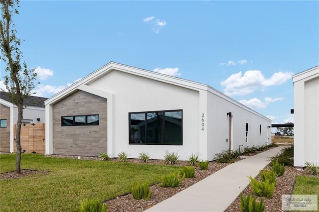 view of property exterior featuring a lawn