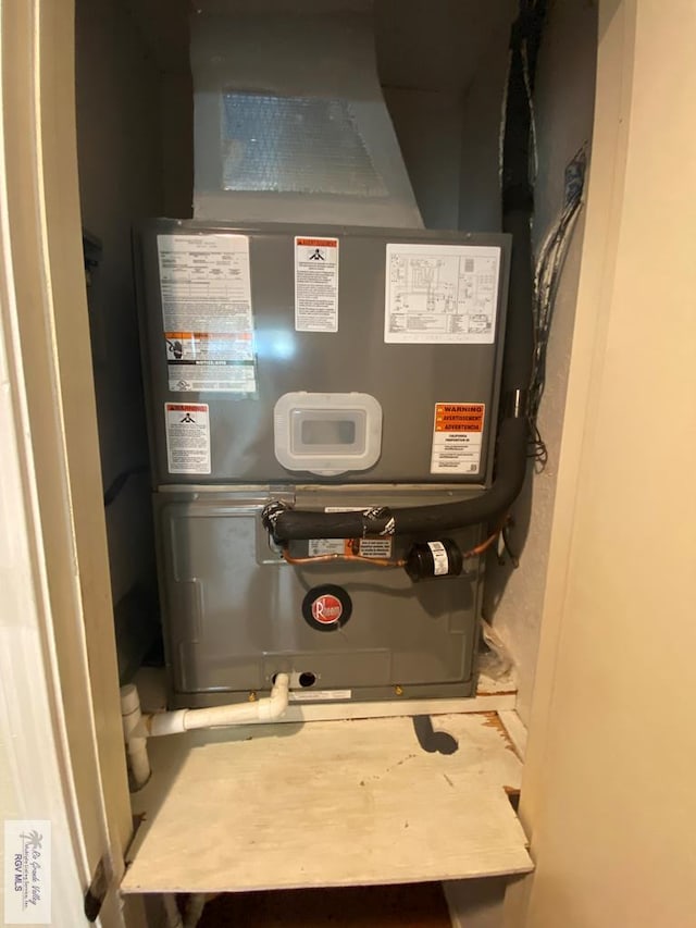 utility room featuring heating unit