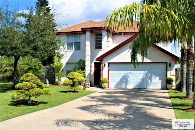 view of front of property featuring brick siding, an attached garage, driveway, and a front yard