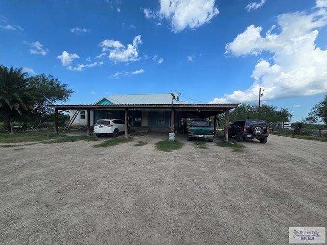 29647 Adams Rd, San Benito, TX 78586 - view of front of property with a carport, metal roof, and driveway