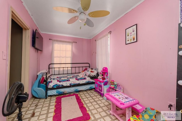 bedroom featuring a ceiling fan, tile patterned floors, and ornamental molding