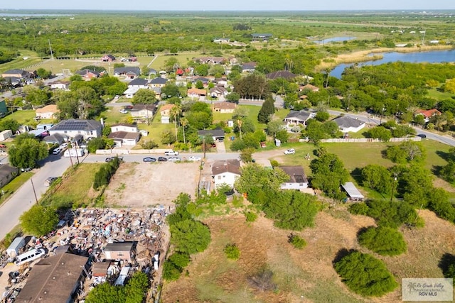 drone / aerial view with a water view and a residential view