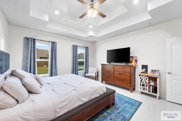 bedroom featuring a tray ceiling and ceiling fan