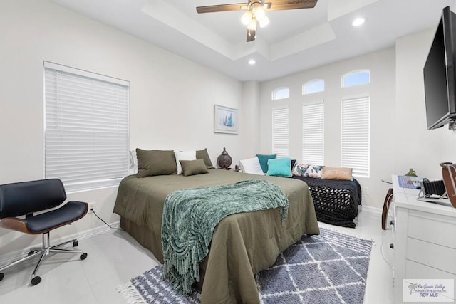 bedroom featuring a tray ceiling and ceiling fan