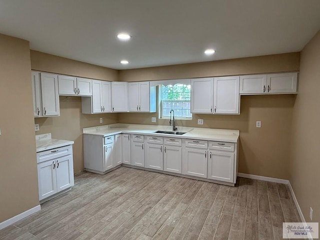 118 E Matz Ave, Harlingen, TX 78550 - kitchen featuring light wood-type flooring, white cabinetry, light countertops, and recessed lighting