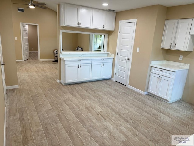 118 E Matz Ave, Harlingen, TX 78550 - kitchen with light countertops, white cabinetry, light wood-style floors, and recessed lighting