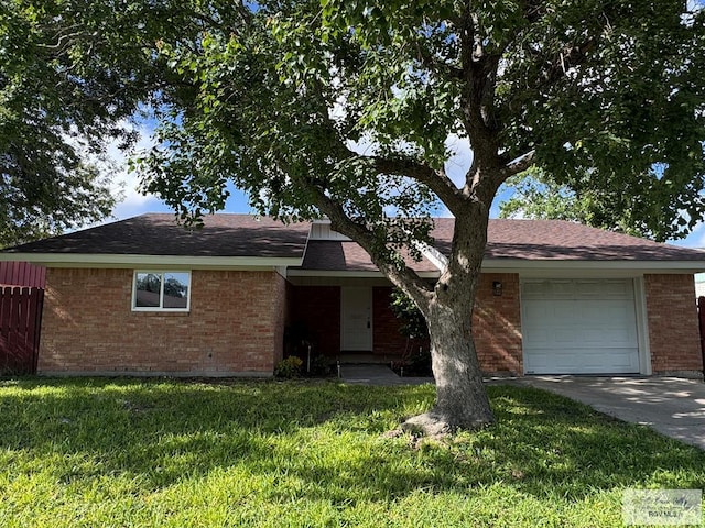 118 E Matz Ave, Harlingen, TX 78550 - single story home with a garage, brick siding, a front yard, concrete driveway, and roof with shingles