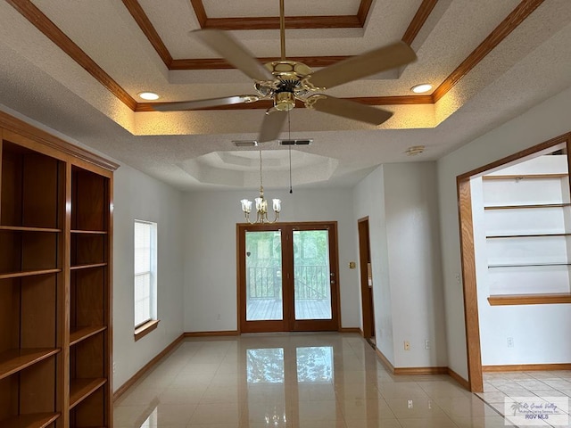 entryway featuring a textured ceiling, a raised ceiling, and a healthy amount of sunlight