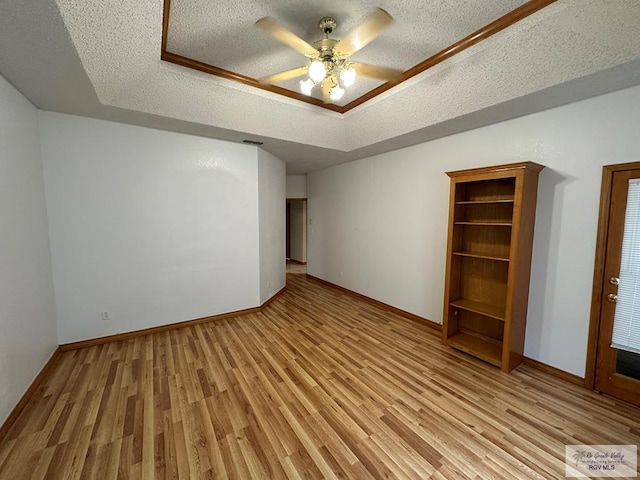 interior space featuring ceiling fan, a textured ceiling, and light hardwood / wood-style flooring