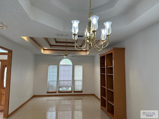 tiled spare room featuring ceiling fan with notable chandelier, a raised ceiling, ornamental molding, and a textured ceiling