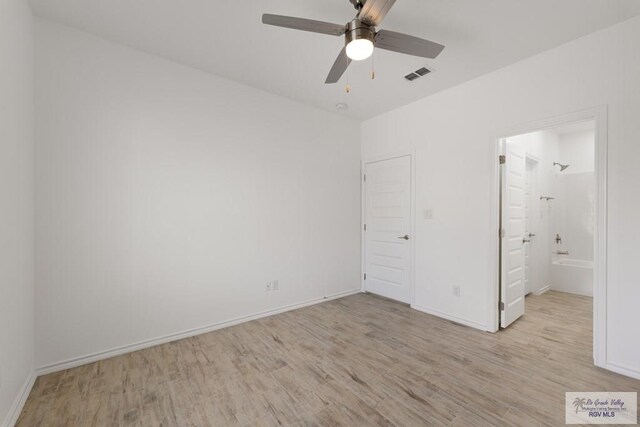 unfurnished bedroom with connected bathroom, ceiling fan, and light hardwood / wood-style floors