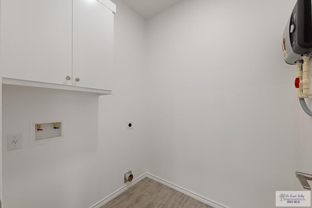 washroom featuring cabinets, washer hookup, light wood-type flooring, and electric dryer hookup