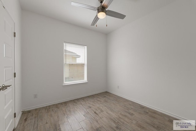 spare room featuring light wood-type flooring and ceiling fan